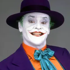 Jack Nicholson nel suo iconico ruolo di Joker, primo film, con trucco bianco, capelli verdi e cappello viola.