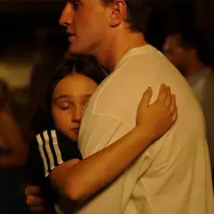 Un abbraccio intenso, una bambina si stringe a un uomo. Una scena che fa pensare a un momento di conforto, quasi una spiegazione dopo il sole.