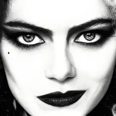 Primo piano di Cruella con capelli bicolore, trucco drammatico e labbra scure. Le sue recensioni sono sempre intense.