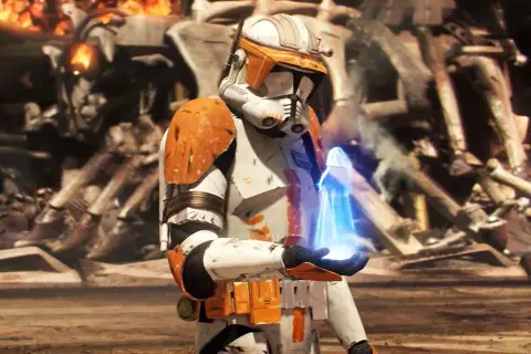 Un clone trooper con armatura arancione tiene un oggetto blu luminoso. Sullo sfondo, rovine e fiamme, un momento chiave dei Clone Wars ordine cronologico.