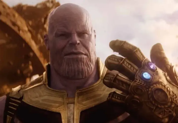 Thanos, il Titano Pazzo, mostra il Guanto dell'Infinito, con le gemme che brillano. Il suo sguardo è ineluttabile, pronto a realizzare il suo piano.