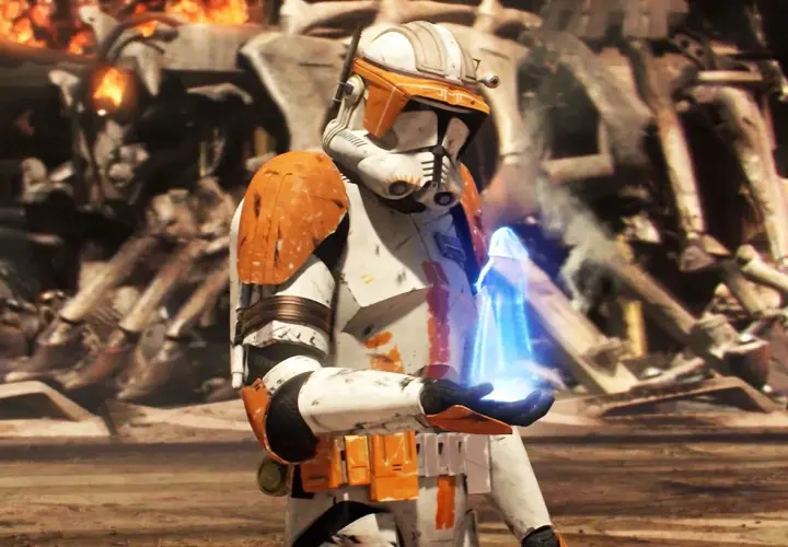 Un clone trooper con armatura arancione tiene un oggetto blu luminoso. Sullo sfondo, rovine e fiamme, un momento chiave dei Clone Wars ordine cronologico.