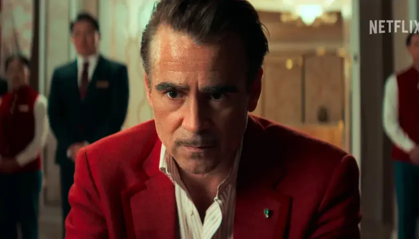Colin Farrell in un film Netflix, con un'espressione intensa, indossa una giacca rossa.