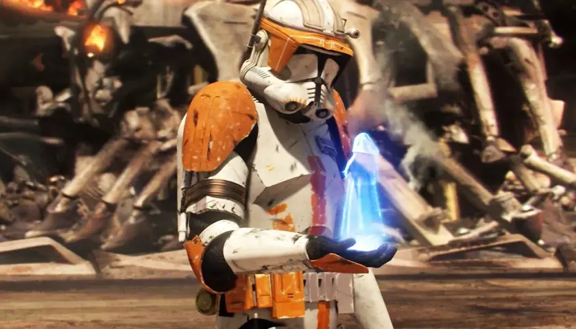 Un clone trooper con armatura arancione tiene un oggetto blu luminoso. Sullo sfondo, rovine e fiamme, un momento chiave dei Clone Wars ordine cronologico.