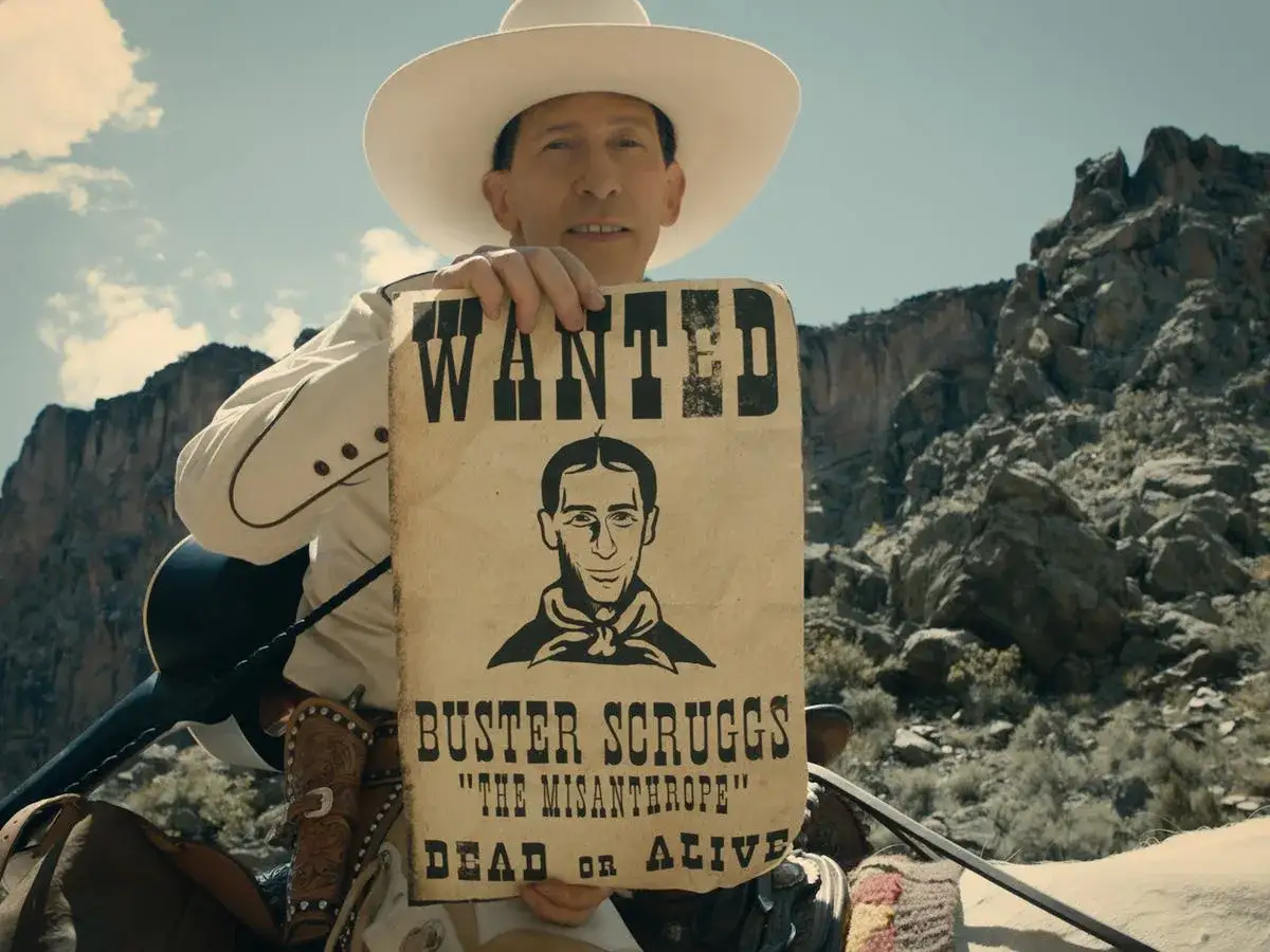 Un uomo con cappello da cowboy mostra un poster